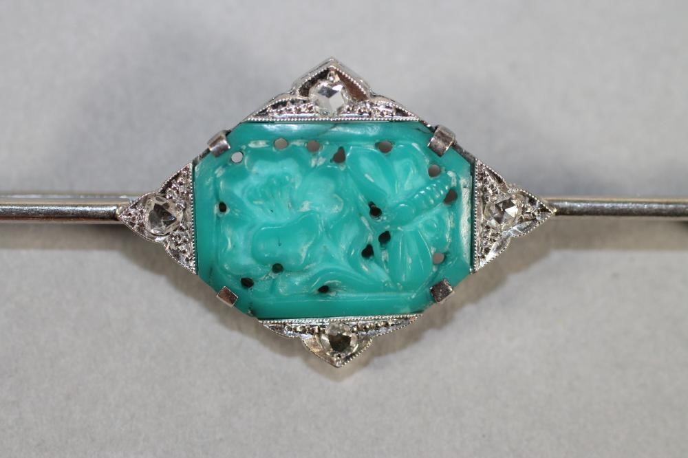AN ART DECO BAR BROOCH centred by an oblong turquoise panel pierced and carved with an insect and Image