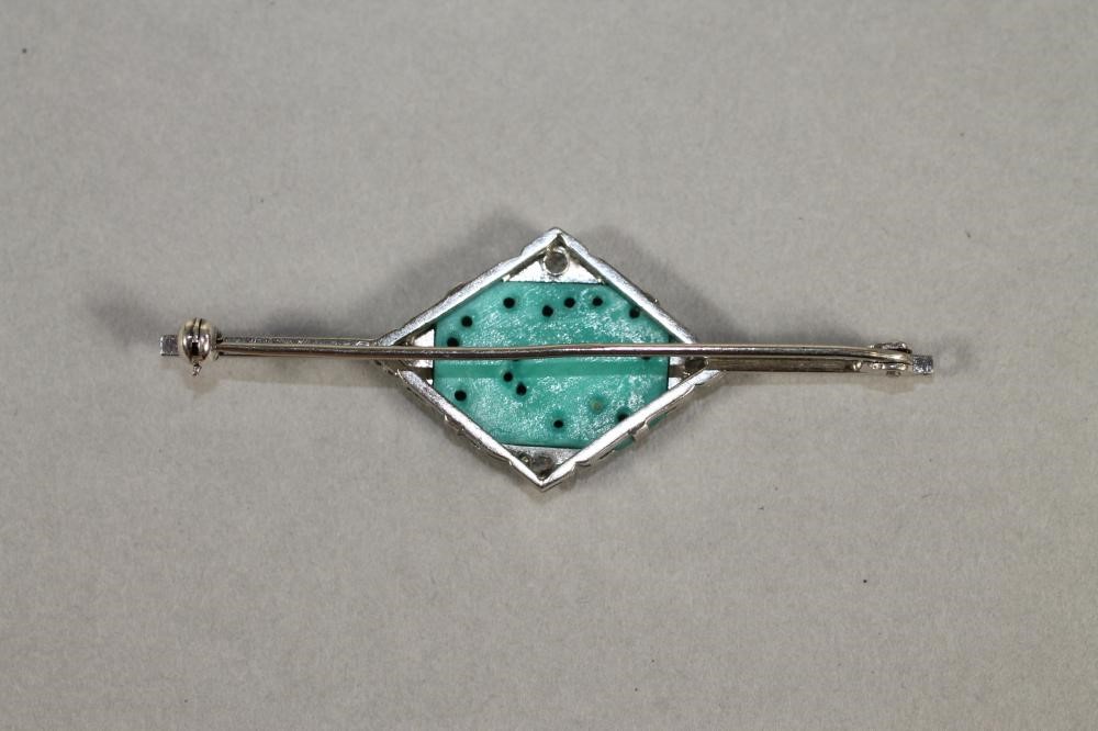 AN ART DECO BAR BROOCH centred by an oblong turquoise panel pierced and carved with an insect and Image