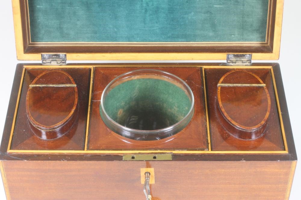 A LATE GEORGE III MAHOGANY TEA CADDY of plain oblong form with satinwood and ebony stringing Image