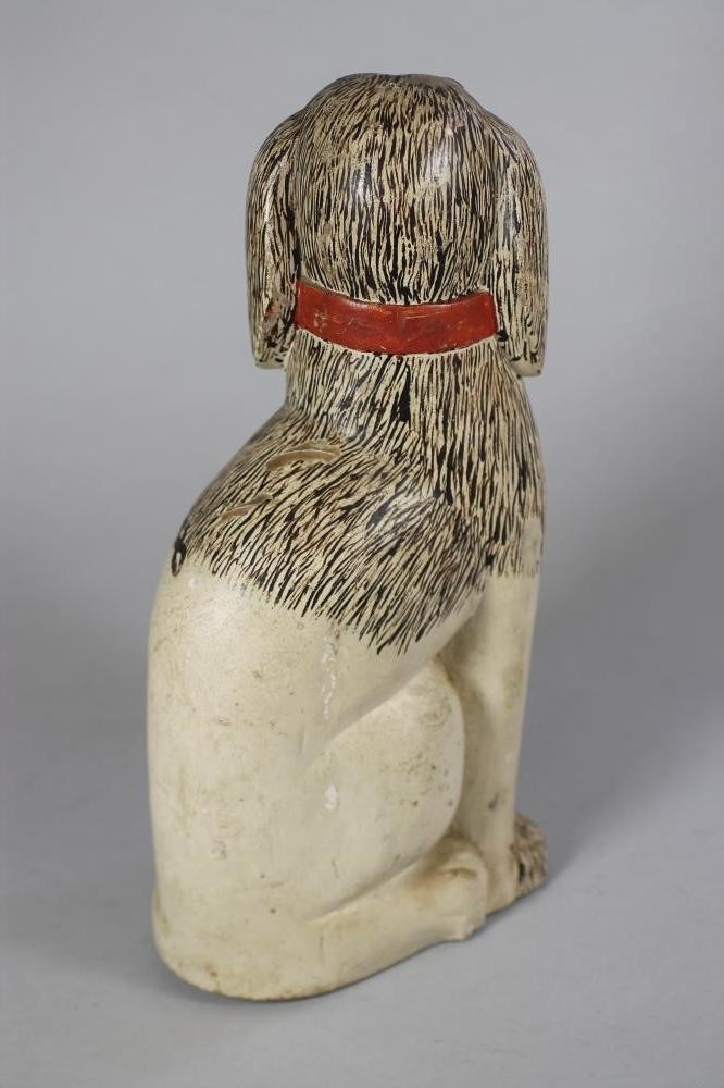 A VICTORIAN NAIVE SOFTWOOD CARVED AND PAINTED SPANIEL Image