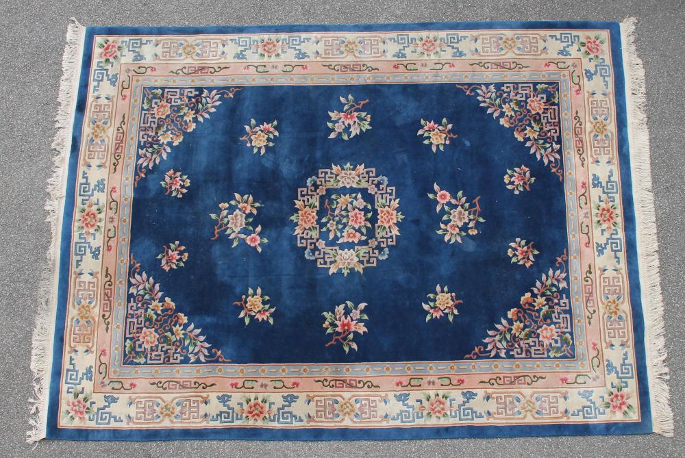 A CHINESE WASHED AND FRINGED CARPET Image