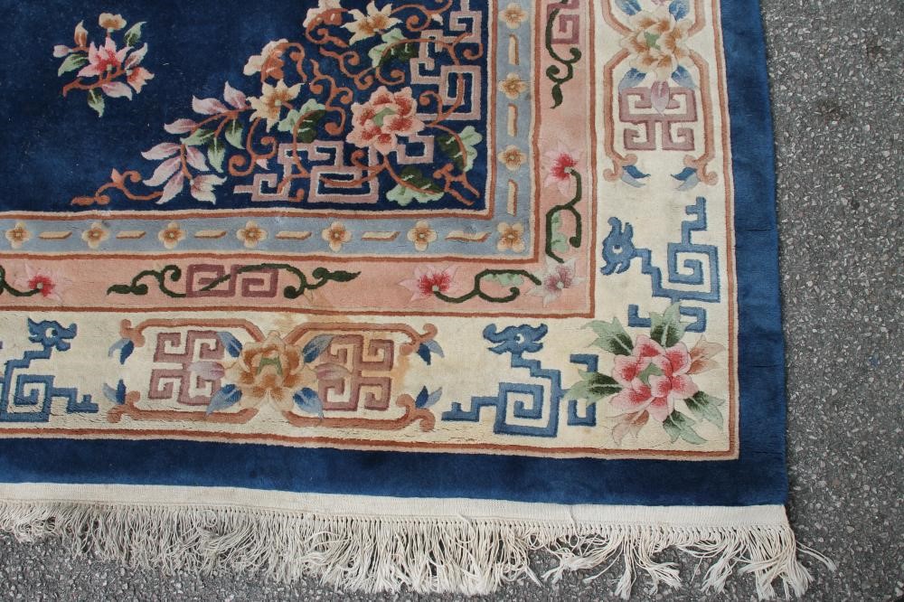 A CHINESE WASHED AND FRINGED CARPET Image