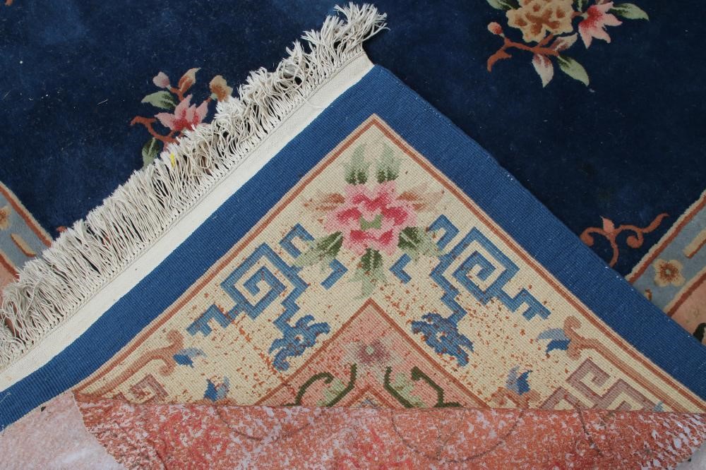 A CHINESE WASHED AND FRINGED CARPET Image