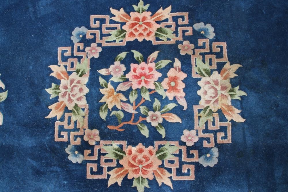 A CHINESE WASHED AND FRINGED CARPET Image