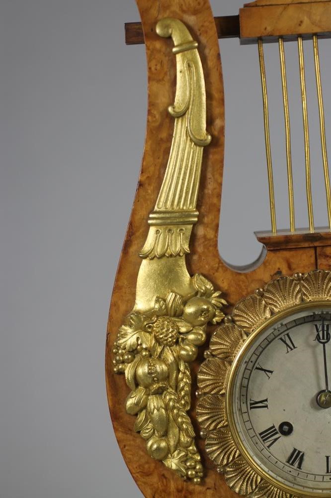 A FRENCH BURR MAPLE AND ORMOLU MANTEL CLOCK Image