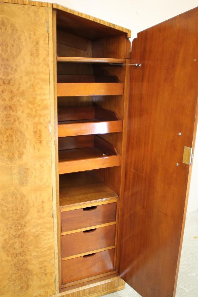 AN ART DECO BURR MAPLE VENEERED TRIPLE WARDROBE of arched stepped tapering form with zebra wood Image