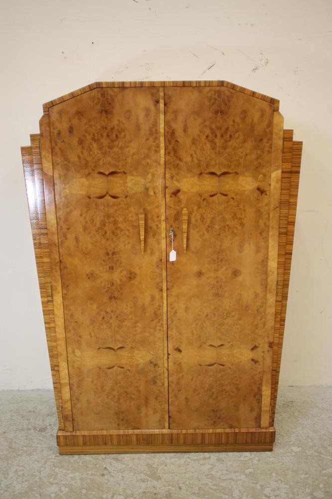 AN ART DECO BURR MAPLE VENEERED TRIPLE WARDROBE of arched stepped tapering form with zebra wood Image