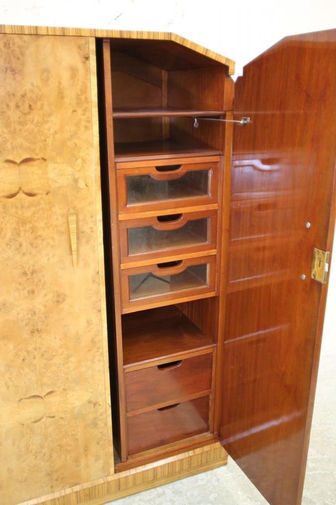 AN ART DECO BURR MAPLE VENEERED TRIPLE WARDROBE of arched stepped tapering form with zebra wood Image
