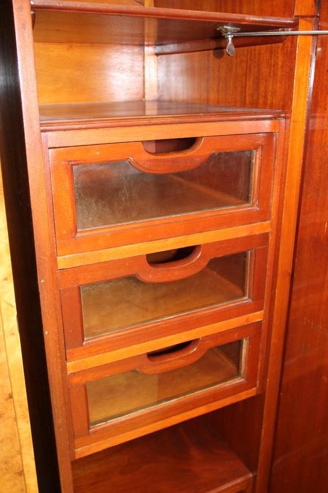 AN ART DECO BURR MAPLE VENEERED TRIPLE WARDROBE of arched stepped tapering form with zebra wood Image
