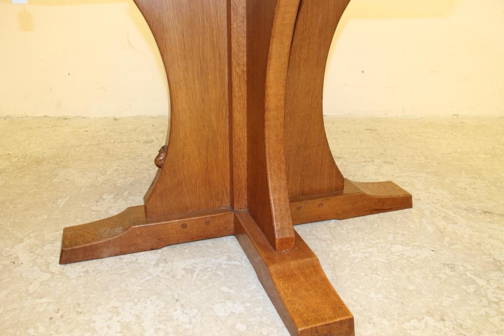 AN ADZED OAK DINING TABLE by Robert Thompson Image