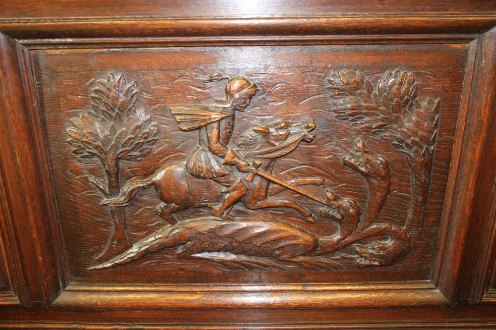 A LATE VICTORIAN CARVED OAK SETTLE Image