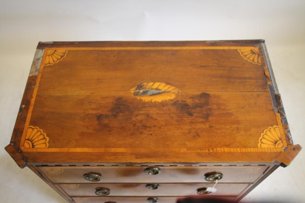 A NORTHERN EUROPEAN MAHOGANY AND MARQUETRY INLAID COMMODE Image