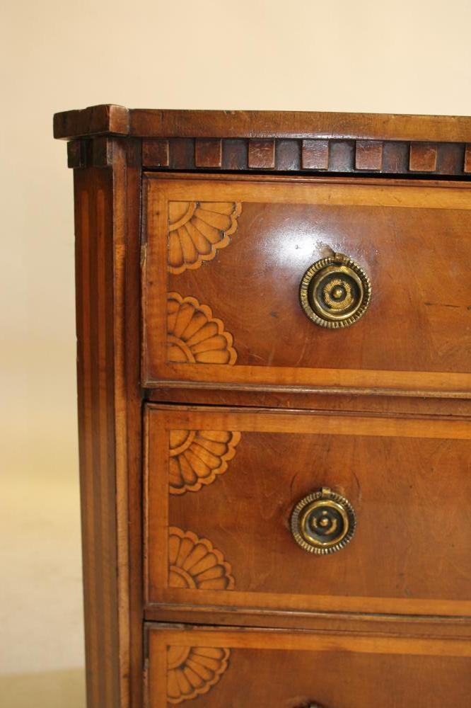 A NORTHERN EUROPEAN MAHOGANY AND MARQUETRY INLAID COMMODE Image