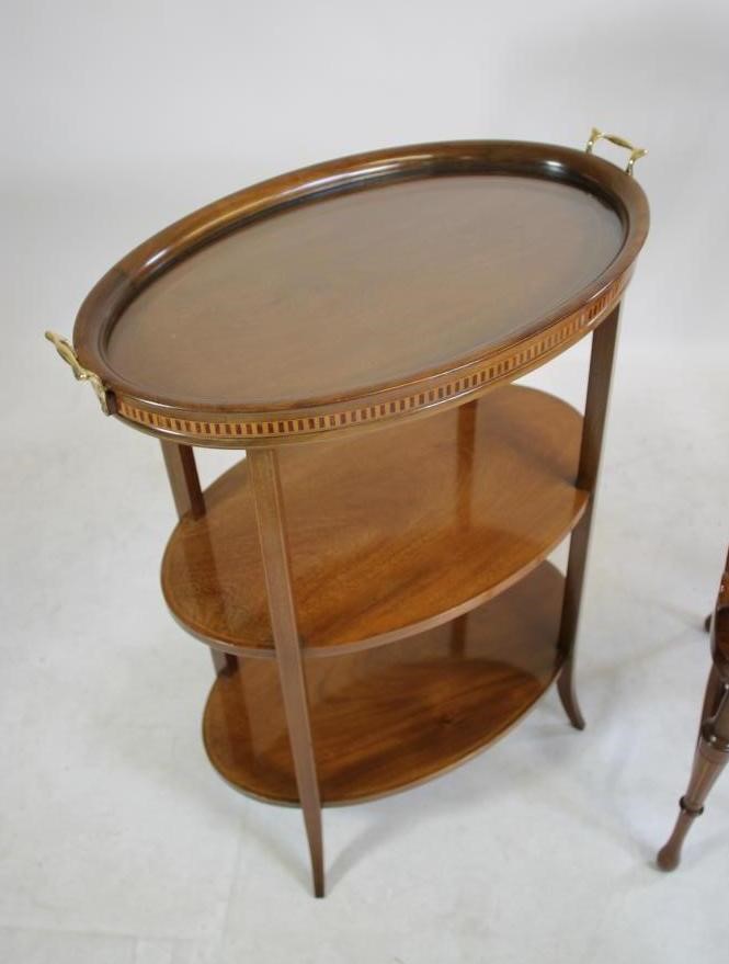 AN EDWARDIAN MAHOGANY ETAGERE of three tier oval form with stringing Image