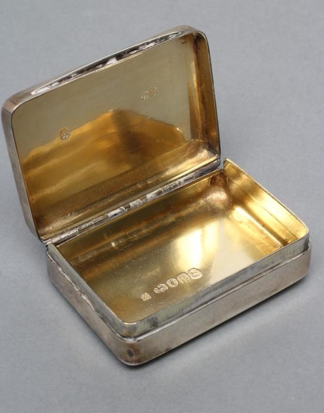 A LATE GEORGE III SILVER SNUFF BOX Image