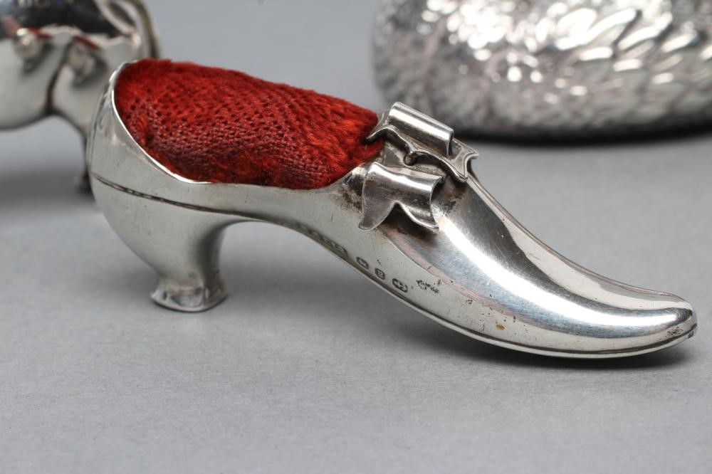 THREE NOVELTY SILVER PIN CUSHIONS comprising a shoe with bow and buckle on a Louis heel Image