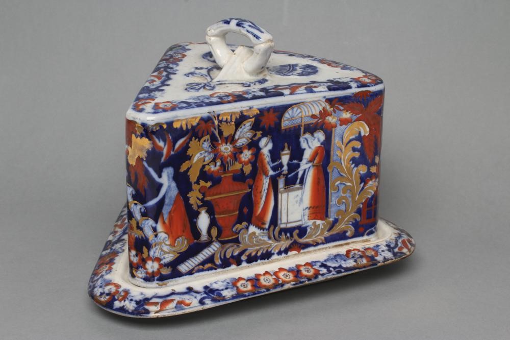 A VICTORIAN STAFFORDSHIRE POTTERY CHEESE WEDGE AND STAND printed in underglaze blue and overpainted Image