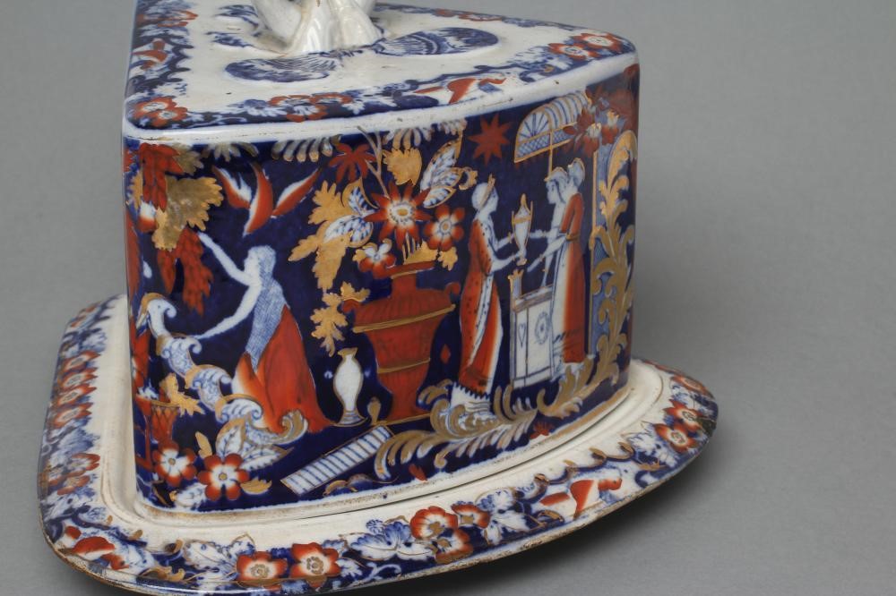 A VICTORIAN STAFFORDSHIRE POTTERY CHEESE WEDGE AND STAND printed in underglaze blue and overpainted Image