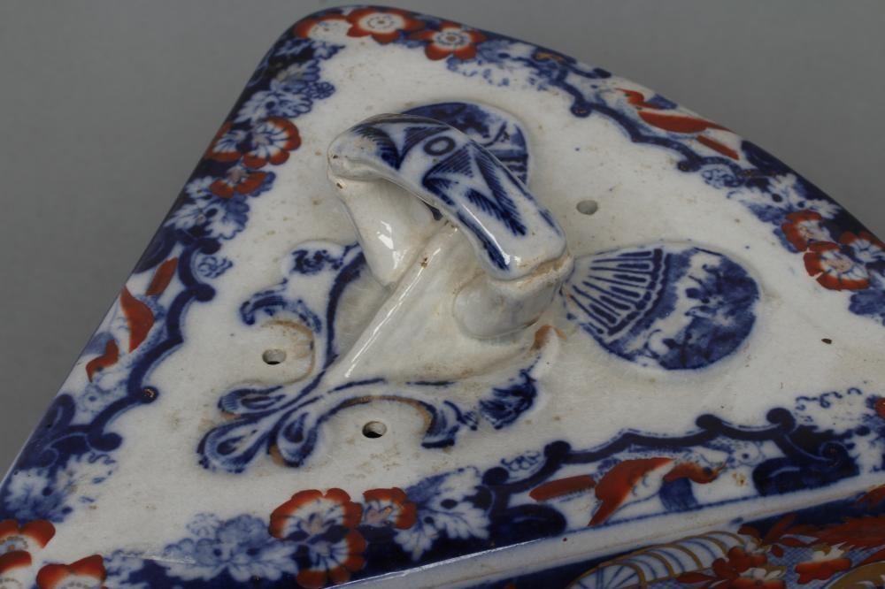 A VICTORIAN STAFFORDSHIRE POTTERY CHEESE WEDGE AND STAND printed in underglaze blue and overpainted Image