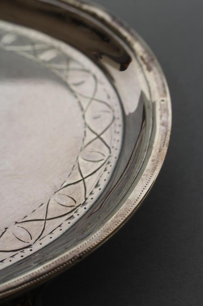 A LATE GEORGE III TEAPOT STAND Image