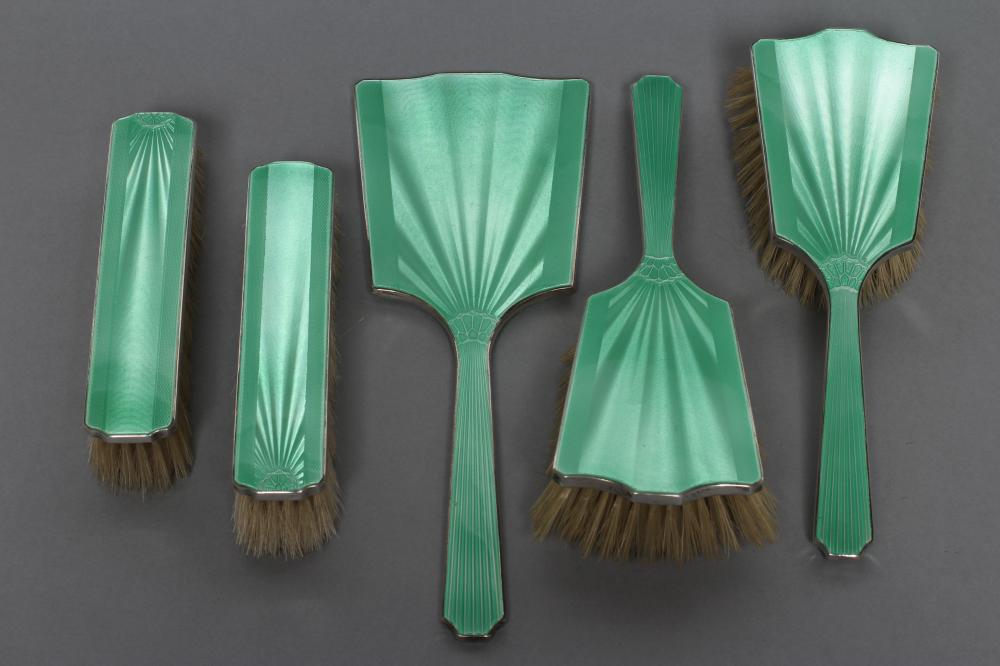 AN ART DECO SILVER AND GREEN ENAMEL COMPOSITE FIVE PIECE DRESSING TABLE SET Image