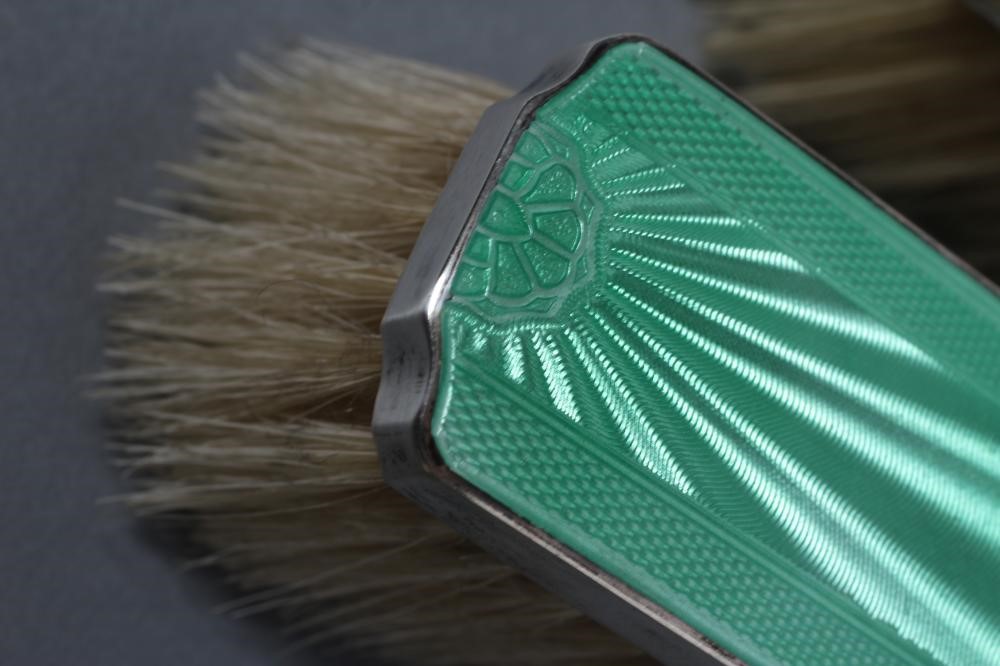 AN ART DECO SILVER AND GREEN ENAMEL COMPOSITE FIVE PIECE DRESSING TABLE SET Image