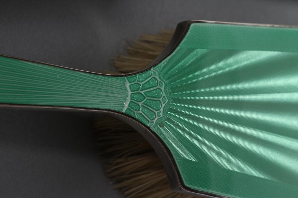 AN ART DECO SILVER AND GREEN ENAMEL COMPOSITE FIVE PIECE DRESSING TABLE SET Image