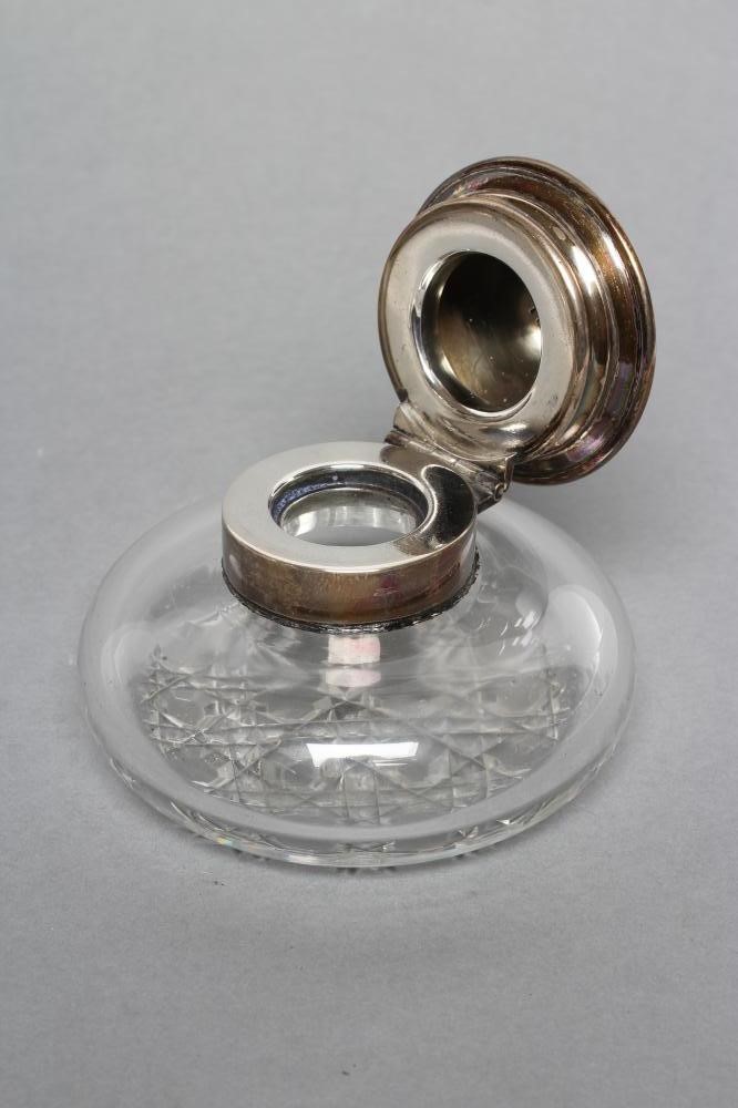 A LATE VICTORIAN CLEAR GLASS INKWELL Image