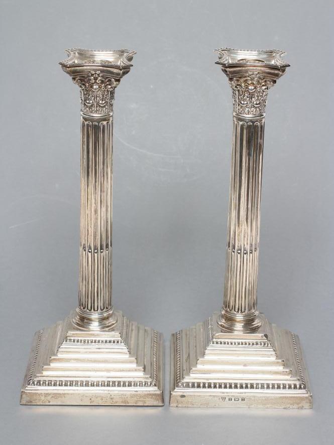 A COMPOSITE PAIR OF CORINTHIAN COLUMN CANDLESTICKS Image