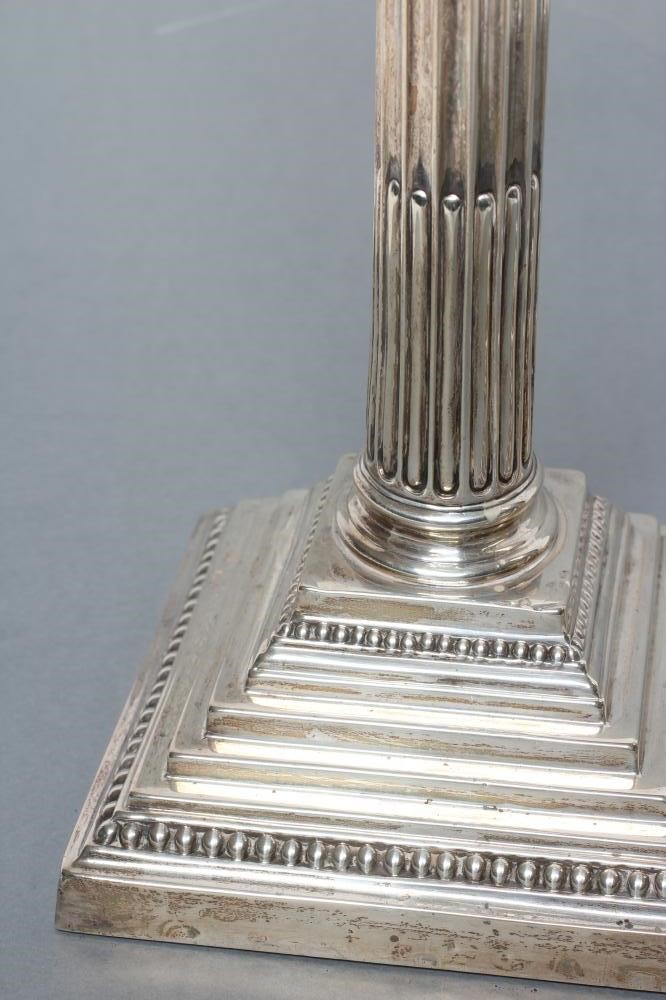 A COMPOSITE PAIR OF CORINTHIAN COLUMN CANDLESTICKS Image