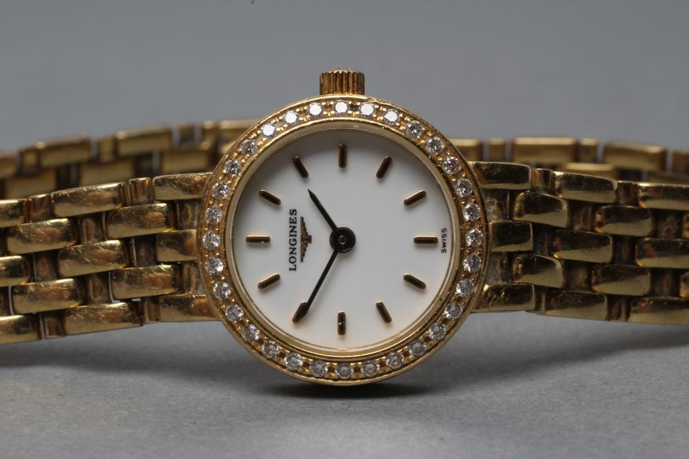 A LADY'S LONGINES 18CT GOLD AND DIAMOND WRISTWATCH Image