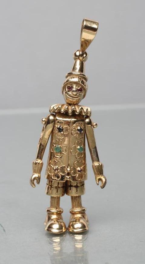 A 9CT GOLD ARTICULATED CLOWN PENDANT with ruby eyes Image
