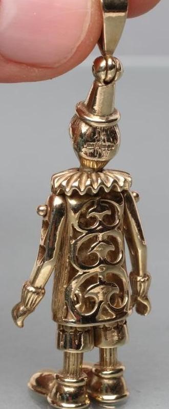 A 9CT GOLD ARTICULATED CLOWN PENDANT with ruby eyes Image