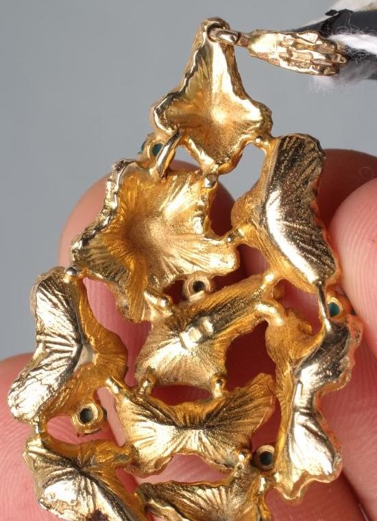 A MODERNIST ABSTRACT PENDANT of open tear drop form claw set with six turquoise beads Image