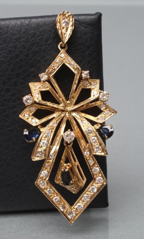 A DIAMOND AND SAPPHIRE PENDANT of open multi lozenge form pave set with numerous small mixed cut Image