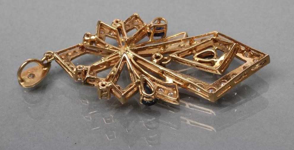 A DIAMOND AND SAPPHIRE PENDANT of open multi lozenge form pave set with numerous small mixed cut Image