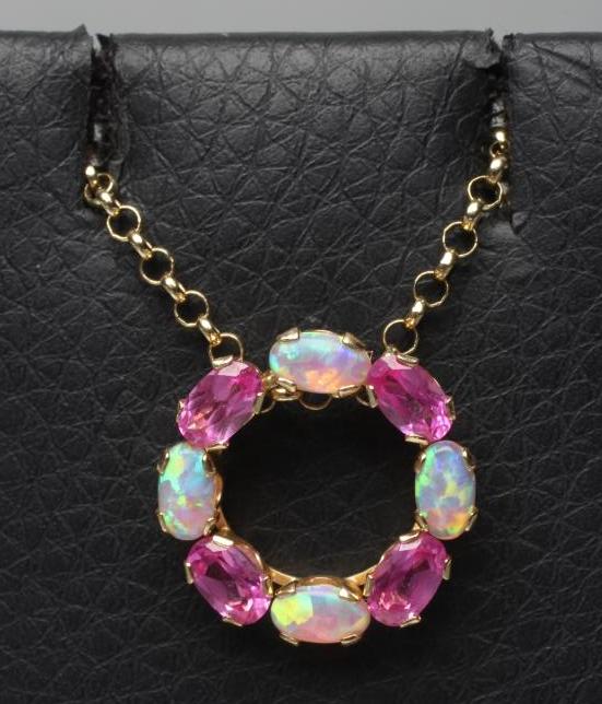 A PINK SAPPHIRE AND OPAL CIRCLET PENDANT claw set with four of each stones fixed to a 9ct gold chain Image