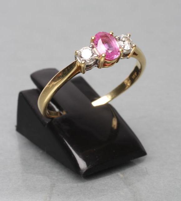 A PINK SAPPHIRE AND DIAMOND THREE STONE RING Image