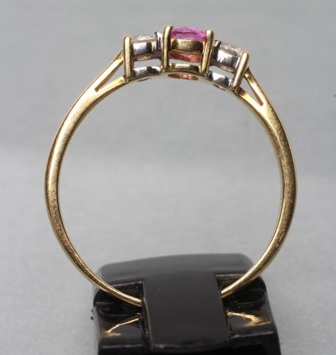 A PINK SAPPHIRE AND DIAMOND THREE STONE RING Image