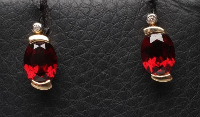 A PAIR OF GARNET AND DIAMOND EAR STUDS Image