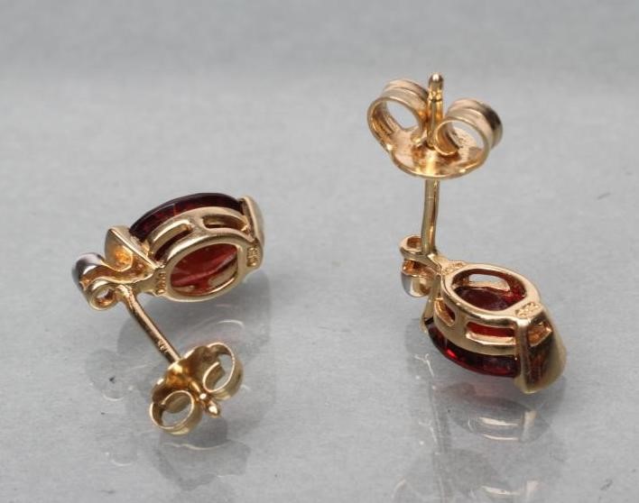 A PAIR OF GARNET AND DIAMOND EAR STUDS Image