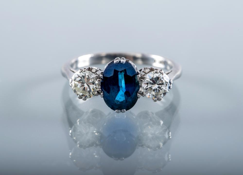 A SAPPHIRE AND DIAMOND THREE STONE RING Image