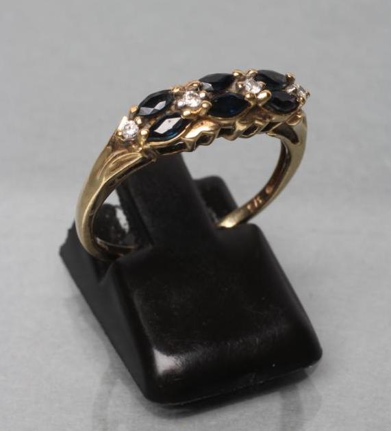 A SAPPHIRE AND DIAMOND HALF HOOP RING Image