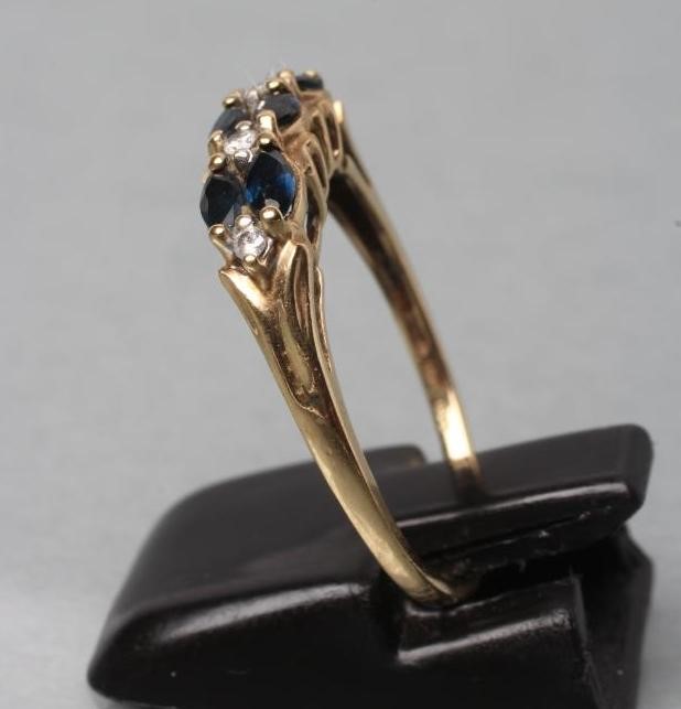 A SAPPHIRE AND DIAMOND HALF HOOP RING Image