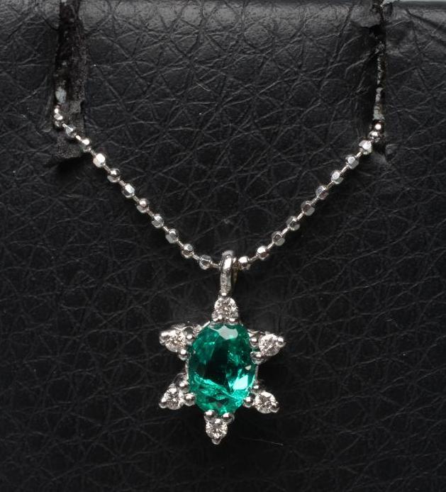 AN EMERALD AND DIAMOND PENDANT Image