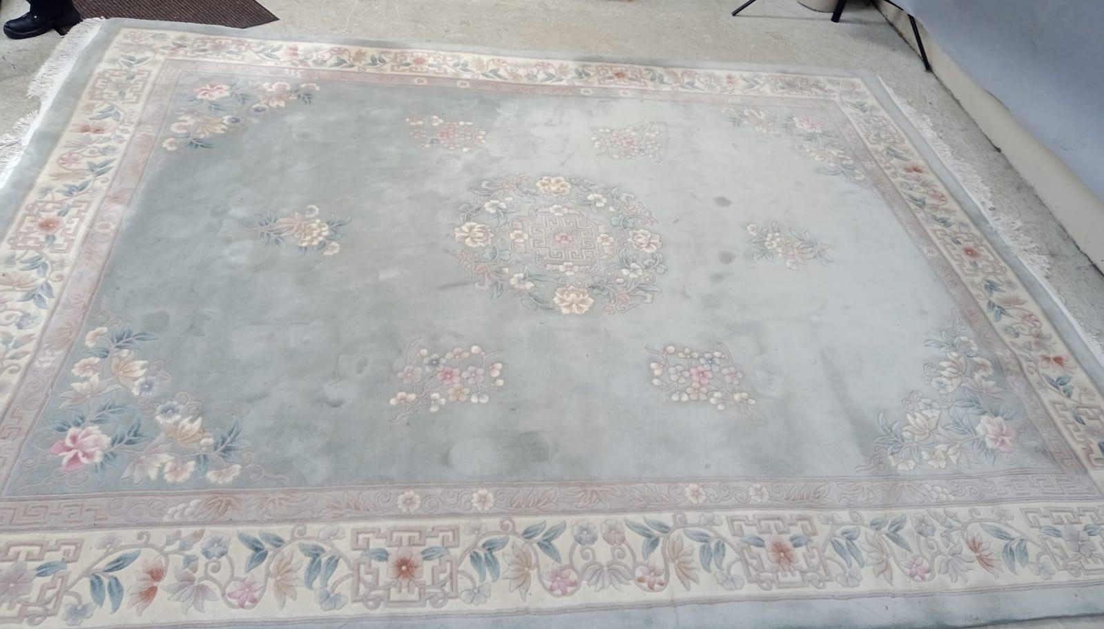 A CHINESE WASHED AND FRINGED CARPET Image