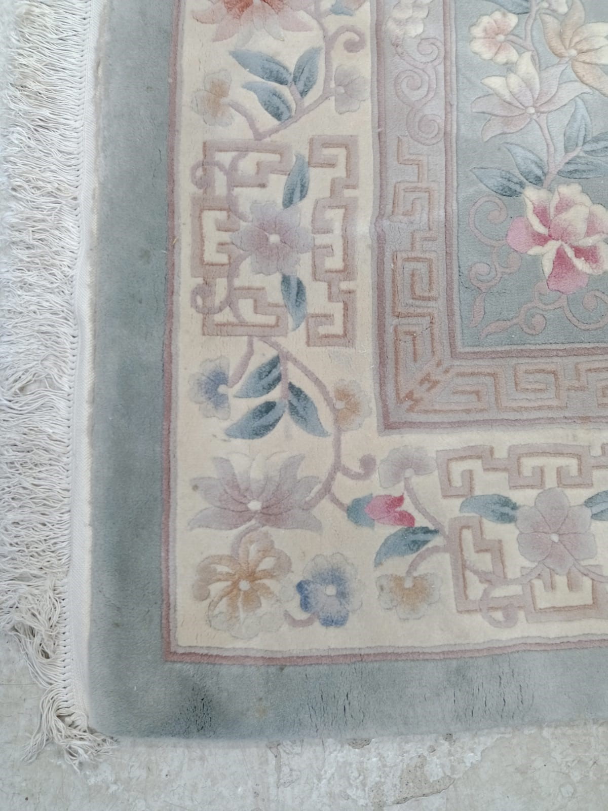 A CHINESE WASHED AND FRINGED CARPET Image