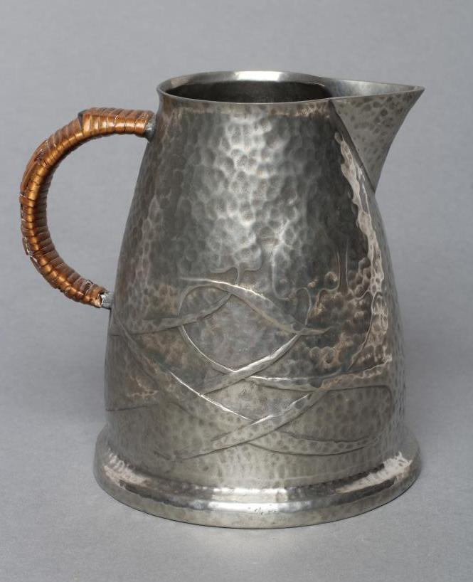 ARCHIBALD KNOX FOR LIBERTY - a Tudric pewter jug of tapering rounded cylindrical form Image