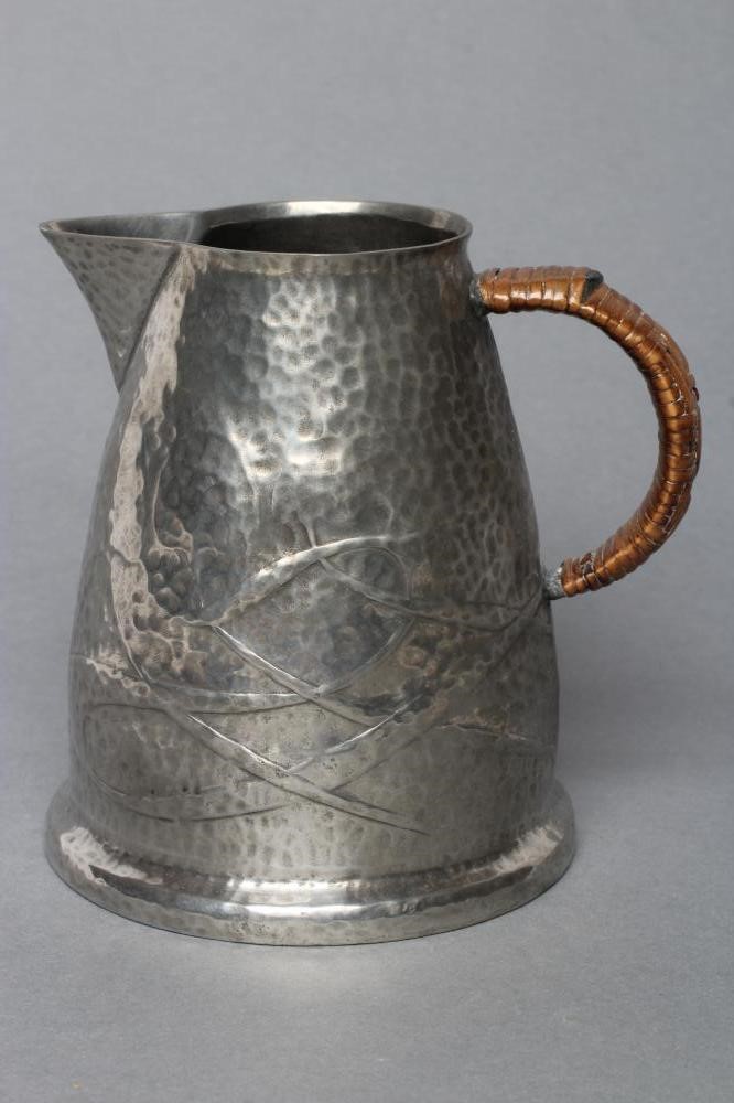 ARCHIBALD KNOX FOR LIBERTY - a Tudric pewter jug of tapering rounded cylindrical form Image