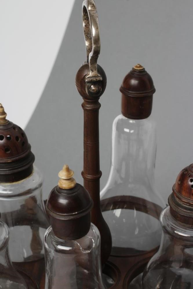 A GEORGIAN HARDWOOD FIVE BOTTLE CRUET AND STAND Image